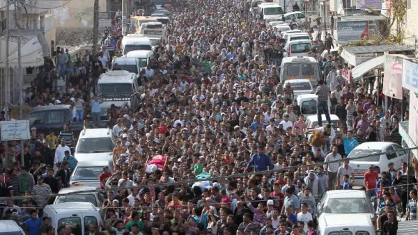 Mourners carry the bodies of Palestinian militants Khaled al-Najjar  and Mussa Fanasheh during their funeral procession on November 27, 2013 in the West Bank village of Yatta, near Hebron. [AFP/Hazem Bader]