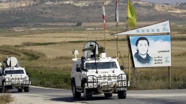 Spanish peacekeepers of the United Nations Interim Force in Lebanon (UNIFIL) patrol in their armoured vehicles near a placard of Hezbollah (AFP/MAHMOUD ZAYYAT) Spanish peacekeepers of the United Nations Interim Force in Lebanon (UNIFIL) patrol in their armoured vehicles near a placard of Hezbollah (AFP/MAHMOUD ZAYYAT)