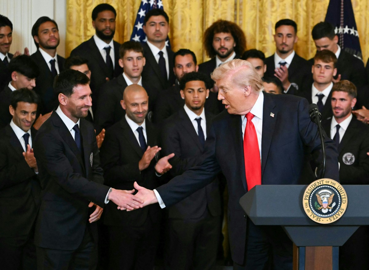 Donald Trump Lionel Messi Photo by ANDREW CABALLERO-REYNOLDS / AFP