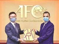 Qatar’s Ambassador to Malaysia Fahd bin Mohammed Kafoud (right) hands over the final part of the bid documents for the 2027 AFC Asian Cup to an Asian Football Confederation official. (Photo: Gulf Times)