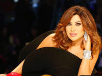 Najwa Karam glowed in a short black one-shouldered dress from Yve Saint Laurent.