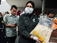 A member of a wildlife personnel team displays a product made from ivory tusks before the confiscated ivory was destroyed at the Kualiti Alam Waste Management centre in Port Dickson on April 30, 2019.  Mohd RASFAN / AFP