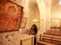 Rita Wahba recites hymns in Aramaic, at the Saint Sarkis monastery in the Syrian mountain village of Maalula, in the Damascus region on May 13, 2019. LOUAI BESHARA / AFP