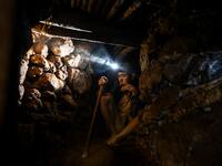 This photo taken on May 16, 2019 shows a miner working in a tunnel in a ruby mine in Mogok, north of Mandalay. Burrowing deep underground, thousands of informal miners risk their lives to find gleaming red gems as a law change spurs opportunity in Myanmar's "land of rubies". Ye Aung THU / AFP
