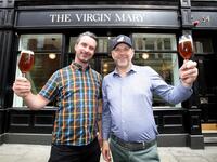 Pub co-owners Oisin Davis (L) and Vaughan Yates pose outside the Virgin Mary pub, which opened recently selling non-alcoholic drinks and is known as the 'pub with no beer', in the city centre of Dublin on May 16, 2019. PAUL FAITH / AFP