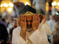 Shiite Muslim worshippers gather for the ritual prayer of Lailat al-Qadr, which marks the night in fasting month of Ramadan during which the Koran was first revealed to Prophet Mohammed in the seventh century, at the Imam Ali shrine in the central Iraqi holy city of Najaf on May 29, 2019. Haidar HAMDANI / AFP