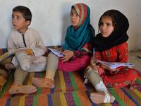 In this photograph taken on May 14, 2019, Hamisha Gul’s grandchildren, who lost their legs following unexploded rocket explosion, attend and study at a class in their house in Khogyani district of Nangarhar province. NOORULLAH SHIRZADA / AFP