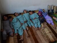 In this photograph taken on May 3, 2019, Hamisha Gul’s sons and grandchildren, who lost their legs following unexploded rocket explosion, rest in their bedroom in Khogyani district of Nangarhar province. NOORULLAH SHIRZADA / AFP