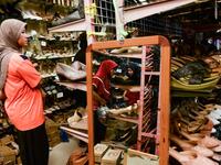 In this picture taken on June 1, 2019 Muslim women browse shoes in a store while shopping for Eid-al-Fitr, which marks the end of the holy month of Ramadan, in Narathiwat.  Madaree TOHLALA / AFP