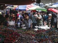Palestinians shop at a market ahead of Eid al-Fitr holiday, celebrating the end of the holy Muslim fasting month of Ramadan, in Gaza City on June 2, 2019.  MAHMUD HAMS / AFP