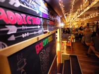 People have a drink at "The Bus Cafe Erbil" in Arbil, the capital of Iraq's Kurdish autonomous region, on June 7, 2019, on the long weekend of the Eid al-Fitr holiday which marks the end of the Muslim holy month of Ramadan.  SAFIN HAMED / AFP