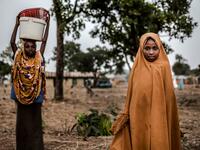 A Fulani girl stands poses for a portrait while attending to the market at Kachia Grazing Reserve, Kaduna State, Nigeria, on April 18, 2019. Luis TATO / AFP