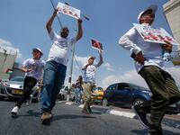 Palestinians hold protest signs showing the crossed-out faces of (L to R) Israeli Prime Minister Benjamin Netanyahu, US President Donald Trump, King Hamad al-Khalifa of Bahrain, and Saudi Crown Prince Mohammed bin Salman. Musa Al SHAER / AFP