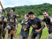 Runners cheer as they take part in the Mud Day, a 13km race with obstacles in Beynes, near Paris on June 16, 2019.  ALAIN JOCARD / AFP