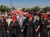 Jordanian security forces create a security perimeter around protesters  participating in the "March of Anger" demonstration leading to the US Embassy  in the Jordanian capital Amman on June 21, 2019, against the US President Donald Trump's "Deal of the Century" and the US-led Middle East economic conference in Bahrain.  Khalil MAZRAAWI / AFP