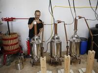 Palestinian distiller Nader Muaddi waits for the alcohol to distill in the West Bank village of Beit Jala, near Bethlehem, on June 16, 2019. In his basement, distiller Muaddi made fewer than 500 bottles of liquor last year, but it is earning global acclaim and reviving interest in the Palestinian alcohol sector. On the outskirts of the city famed for Jesus's birth, the 35-year-old illustrates the handcrafted way he makes Arak, an anise-flavoured drink popular in the Middle East and similar to Greek Ouzo, Fr