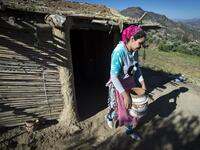 Moroccan potter Houda Oumal from the M'tioua tribe carries one of her pottery works near the village of Ourtzagh in the region of Taounate on june 11, 2019. FADEL SENNA / AFP