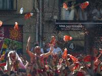 Revellers celebrate during the 'Chupinazo' (start rocket) to mark the kickoff at noon sharp of the San Fermin Festival, in front of the Town Hall of Pamplona, northern Spain, on July 6, 2019.  PIERRE-PHILIPPE MARCOU / AFP