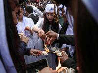 Iraqi Yazidi women light candles outside the Temple of Lalish, in a valley near the Kurdish city of Dohuk about 430 kilometres northwest of the capital Baghdad, on April 16, 2019, during a ceremony marking the Yazidi New Year. Of the 550,000 Yazidis in Iraq before the Islamic State (IS) group invaded their region in 2014, around 100,000 have emigrated abroad and 360,000 remain internally displaced. Roughly 3,300 Yazidis have returned from IS captivity in the last five years, only 10 percent of them men. SAF