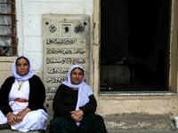 Iraqi Yazidi women sit outside the Temple of Lalish, in a valley near the Kurdish city of Dohuk about 430 kilometres northwest of the capital Baghdad, on April 16, 2019, during a ceremony marking the Yazidi New Year. Roughly 3,300 Yazidis have returned from IS captivity in the last five years, only 10 percent of them men. SAFIN HAMED /