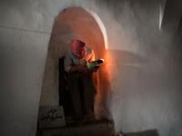 An Iraqi Yezidi visits the Temple of Lalish, in a valley near the Kurdish city of Dohuk about 430km northwest of the capital Baghdad, on July 16, 2019. Of the 550,000 Yazidis in Iraq before the Islamic State (IS) group invaded their region in 2014, around 100,000 have emigrated abroad and 360,000 remain internally displaced. Roughly 3,300 Yazidis have returned from IS captivity in the last five years, only 10 percent of them men. SAFIN HAMED / AFP