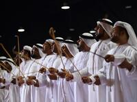 Emirati musicians perform during the annual Liwa Date Festival in the western region of Liwa on July 17, 2019. The Liwa Date Festival aims to preserve Emirati heritage, specifically palm trees and half-ripe dates, knows as "ratab", which are deep-rooted in the Gulf country's traditions. Karim SAHIB / AFP