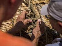 Members of the crew assemble the 14-meter long sailing reed boat Abora IV in the town of Beloslav, Bulgaria, on July 25, 2019. A team of two dozen researchers and volunteers from eight countries are preparing to set out in mid-August on a 1,300 kilometres (700 nautical mailes or 800 miles) journey to test the hypothesis that prehistoric trade routes traversed the high seas. NIKOLAY DOYCHINOV / AFP