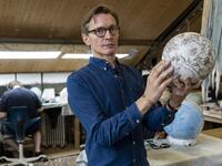 Artisan globemaker, Peter Bellerby poses for a photograph at the Bellerby and Co Globemakers' workshop and headquarters in Stoke Newington in north London, on July 19, 2019. Niklas HALLE'N / AFP