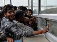 Labourers from across India working in Kashmir buy bus tickets at a counter of Jammu and Kashmir Tourist Reception Centre (JKTRC) to leave the city due to the heightened security situation in Srinagar  Sajjad HUSSAIN / AFP
