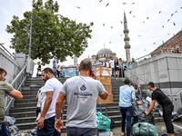 Shop owners try to save their belongings in a flooded undergate shop center in Eminonu district, Istanbul, after a heavy rainfall, on August 17, 2019. Turkey's mega city Istanbul was lashed by a heavy rainstorm on August 17, killing a homeless man and leaving parts of the historic Grand Bazaar flooded.  Ozan KOSE / AFP