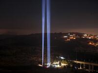 This picture shows a light show in tribute to New York City's World Trade Centre Twin Towers on the eve of the 18th anniversary of the September 11, 2001 terror attacks, at the 9/11 Living Memorial Plaza on a hill overlooking Jerusalem. AHMAD GHARABLI / AFP