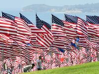 People visit the Pepperdine Wave of Flags display at Pepperdine University in Malibu, California, commemorating those who died in the September 11, 2001 attacks with 2,977 flags. Frederic J. BROWN / AFP