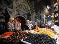 Women run errands at the Bzourieh market in the center of Damascus. LOUAI BESHARA / AFP