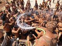 Syrian Turkish-backed fighters from al-Mutasim Brigade shower after finishing their training at a camp near the town of Marea in Syria's northern Aleppo district, on September 12, 2019. Nazeer Al-khatib / AFP