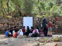 The classes are given in a field outside the school which was under construction but was never completed when funding was stopped due to the war that broke out in Yemen in 2015. AHMAD AL-BASHA / AFP