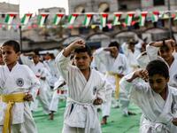 Young Palestinian karatekas demonstrate their skills during a Karate promotion ceremony at a sporting centre in the Rafah camp for Palestinian refugees in the southern Gaza Strip on September 20, 2019. SAID KHATIB / AFP