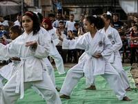 Young Palestinian karatekas demonstrate their skills during a Karate promotion ceremony at a sporting centre in the Rafah camp for Palestinian refugees in the southern Gaza Strip on September 20, 2019. SAID KHATIB / AFP