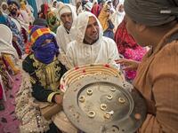 Young Amazigh (Berber) men and women wait for their wedding ceremony during the annual "Engagement Moussem" festival near the village of Imilchil in central Morocco's high Atlas Mountains on September 21, 2019. Each year in the High Atlas Mountains hamlet of Ait Amer, tribes celebrate with dances and music, the collective wedding of young Amazigh couples during the traditional festival of "Engagement Moussem". FADEL SENNA / AFP