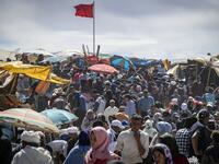 Amazigh (Berber) men and women take part in the annual "Engagement Moussem" festival near the village of Imilchil in central Morocco's high Atlas Mountains on September 21, 2019. Each year in the High Atlas Mountains hamlet of Ait Amer, tribes celebrate with dances and music, the collective wedding of young Amazigh couples during the traditional festival of "Engagement Moussem". FADEL SENNA / AFP
