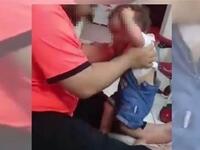 A screen grab from a video that went viral, purportedly showing a man beating a child (social media)