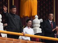 Chinese President Xi Jinping (C) attends a military parade with former presidents Hu Jintao (L) and Jiang Zemin in Tiananmen Square in Beijing on October 1, 2019, to mark the 70th anniversary of the founding of the PeopleÕs Republic of China. GREG BAKER / AFP