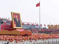 A float with a giant portrait of China's President Xi Jinping passes by Tiananmen Square during the National Day parade in Beijing on October 1, 2019, to mark the 70th anniversary of the founding of the People's Republic of China. GREG BAKER / AFP