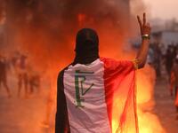 An Iraqi protester gestures the v-sign during a demonstration against state corruption, failing public services and unemployment at Tayaran square in Baghdad on October 2, 2019. Iraq's president and the United Nations urged security forces to show restraint after two protesters were killed in clashes with police that other top officials blamed on "infiltrators." AHMAD AL-RUBAYE / AFP