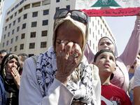 A Lebanese protester wipes her tears during a demonstration in central Beirut's Martyr Square on October 6, 2019. Lebanese protested in the capital over increasingly difficult living conditions, amid fears of a dollar shortage and possible price hikes. ANWAR AMRO / AFP