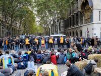 French Gendarmes stand ready as protesters sit on the ground to block the Pont au Change bridge during a demonstration called by climate change activist group Extinction Rebellion, on October 7, 2019 in front of the Conciergerie in Paris. AFP