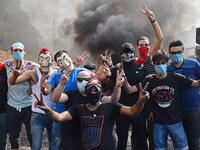 Lebanese protesters block a main road near Beirut-Rafic Hariri International Airport, amidst ongoing protests against dire economic conditions, on October 18, 2019. Public anger has simmered since parliament passed an austerity budget in July to help trim a ballooning deficit and flared on October 17 over new plans to tax calls on messaging applications such as WhatsApp, forcing the government to axe the unpopular proposal. AFP