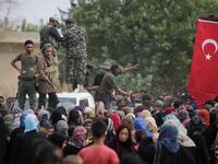 Members of Turkey-backed forces distribute aid provided by the Turkish Red Crescent on October 19, 2019, in the Syrian border town of of Tal Abyad which was seized last week. Bakr ALKASEM / AFP