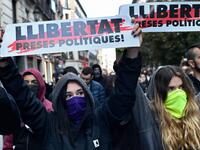 Protesters hold banners reading in Catalan "Freedom for politic prisoners!" during a pro-amnesty demonstration called by Madrid's Anti-repression Movement and demanding total amnesty and the defence of democratic rights and freedoms in Madrid on October 19, 2019. AFP
