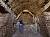 Timnah Goloubin, an archaeologist with the Israel Antiquities Authority, shows on October 23, 2019 the ancient church crypt in the Israeli city of Bet Shemesh. A magnificent 1500-year-old church, decorated with spectacular mosaic floors and Greek inscriptions, was discovered during a three-year excavation near a residential area. MENAHEM KAHANA / afp