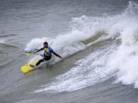 A picture taken on October 10, 2019, shows a kitesurfer riding waves at Dakhla beach in Morocco-administered Western Sahara. In the heart of disputed Western Sahara, a former garrison town has become an unlikely tourist magnet after kitesurfers discovered the windswept desert coast on the Atlantic is perfect for their sport. FADEL SENNA / AFP